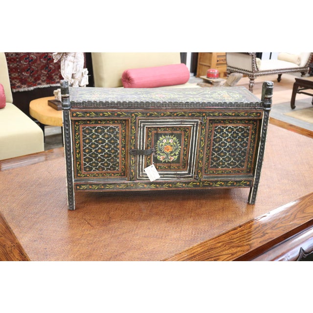 Painted family altar . The altar is painted with floral design. It is a rustic piece with beautiful carving.