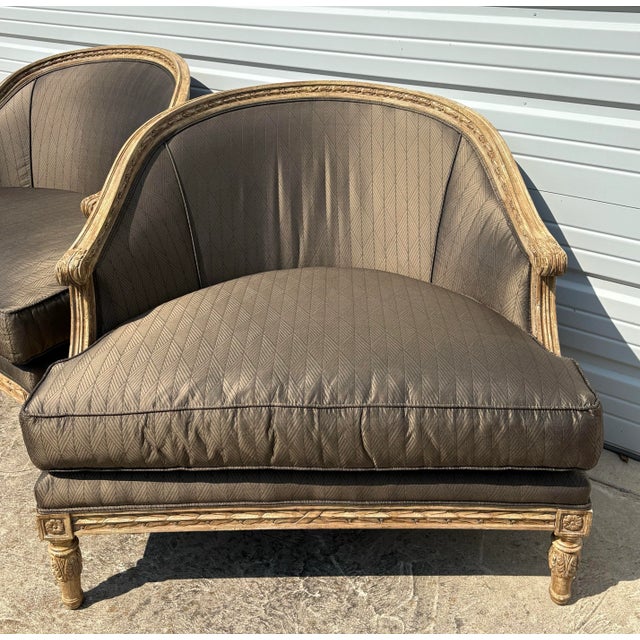 This is a pair of elegant oversized French country style upholstered club chairs. This pair of chairs have a beautifully...