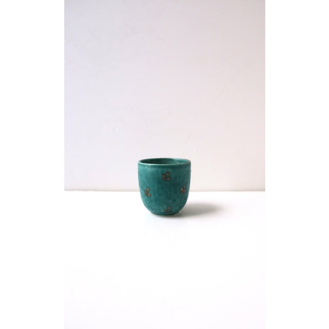A beautiful petite Swedish pottery vessel in a blue/green hue with small sterling silver leaf application, designed by...