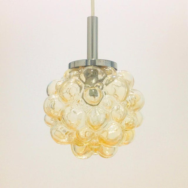 Mid-century modern pendant/ceiling light designed by helena tynell for limburg (germany, 1960s). The amber/champagne...
