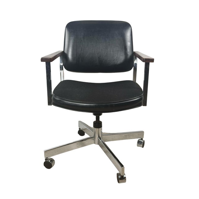 A handsome vintage mid-century modern swivel office chair by United Chair Co. of Leeds, Alabama, combining a polished...