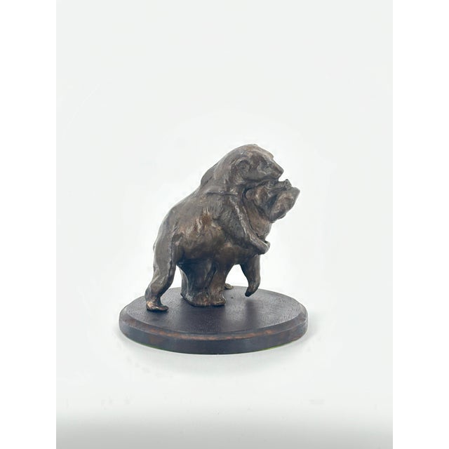 This charming bronze sculpture captures a tender and playful moment between two bears as they share a freshly caught fish....