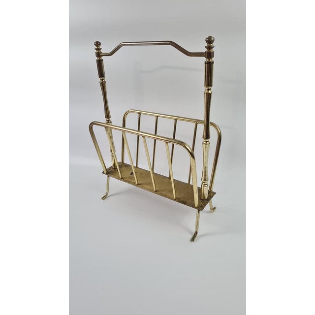 Vintage-style newspaper rack. A newspaper rack from the 1970s in the Hollywood Regency style. It is made of brass-plated...