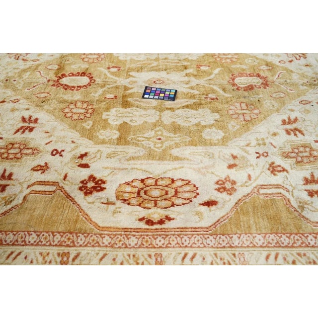 In the Heriz medallion carpet manner, but with a sand subfield on a buff field; buff medallion. Big corner botehs. Salmon-...