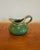 A beautifully rounded ceramic creamer finished in a rich emerald green glaze with subtle tonal variation. The sculptural...