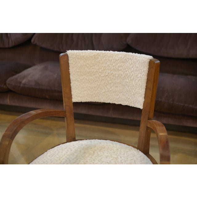An elegant pair of walnut bridge chairs with a balanced and timeless design. Seats and backs reupholstered in ecru boucle...