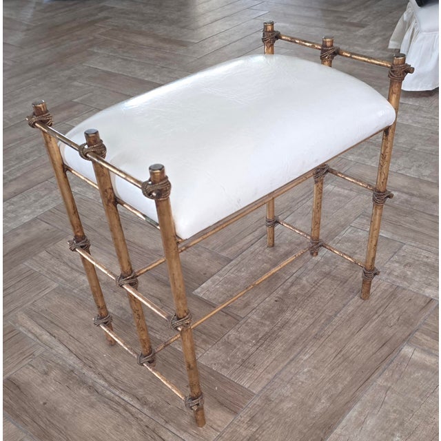 Beautiful vintage Gilt metal stool or bench. Rope and tube Gilt metal details and vintage white leather looking seat cover.