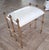 Beautiful vintage Gilt metal stool or bench. Rope and tube Gilt metal details and vintage white leather looking seat cover.