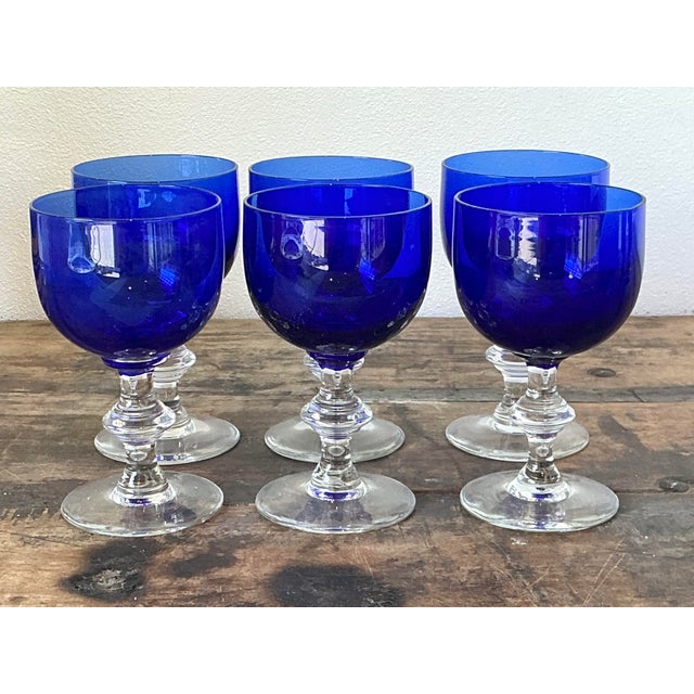 Elevate your tablescape with this stunning set of six vintage stemware glasses, featuring vibrant cobalt blue bowls paired...