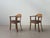 Characterful vintage armchairs from design + handwerk, crafted from warm-toned wood and featuring the original...