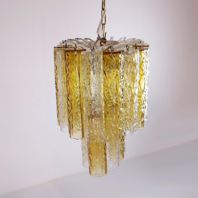 Circa 1970. We offer this Murano Amber and Clear Tronchi Chandelier Venini. The chandelier has a missing piece from the...