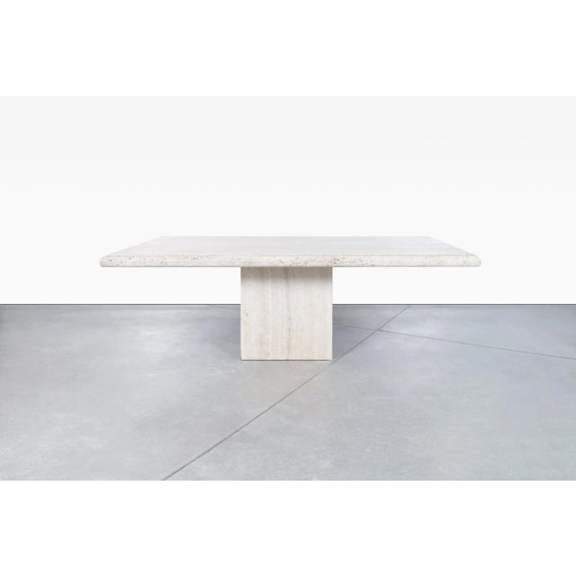 Crafted in Italy during the 1970s, this exceptional vintage travertine dining table by Stone International embodies the...