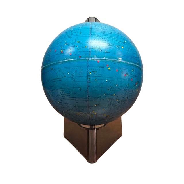 A striking vintage celestial constellation globe featuring a deep blue sphere printed with star maps, constellations, and...