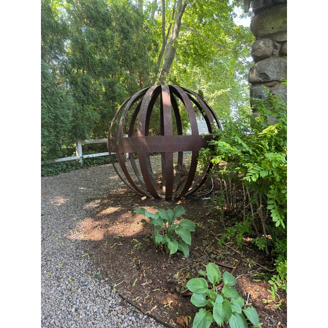 Six foot steel orb garden sculpture from the 1970's. The sculpture can be unbolted resulting in two halves for ease of...
