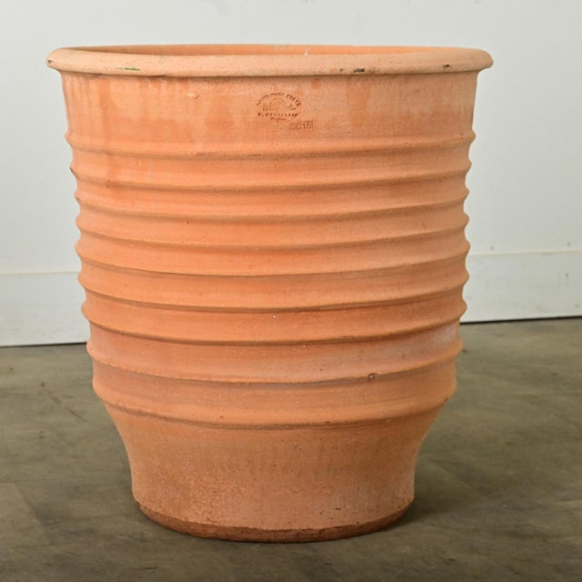 Dimensions: 25 ⅝” H x 22 ½” W x 22 ½” D A pair of reproduction terracotta planters, made on the island of Crete, Greece,...