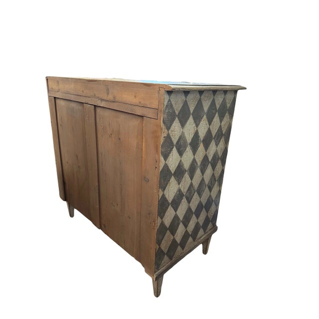 This charming hand painted French commode brings whimsy and uniqueness with its painted harlequin detail. Constructed out...