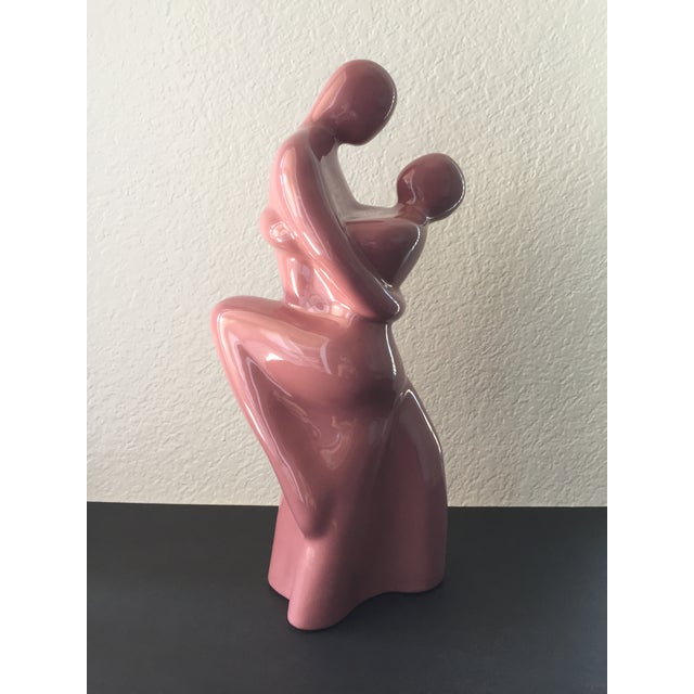 A vintage Haeger Pottery ceramic sculpture depicting a couple dancing the tango. The figures feature a dusty rose color...