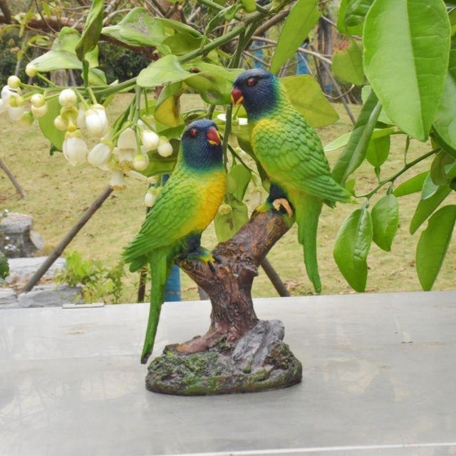 This charming realistic parakeet figurine brings a touch of nature and color to any interior or garden space. Crafted from...