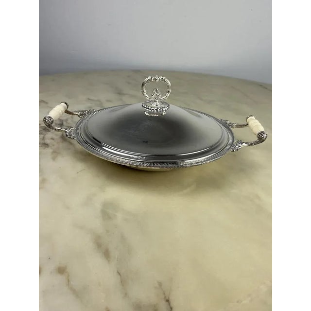 Very elegant, with lid. The handles are covered with fine white porcelain. 36 cm wide, weighs 1130.00 grams. Produced in...