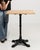 An authentic French bistro table combining a sturdy cast iron base with a warm oak top. The contrast of materials creates...