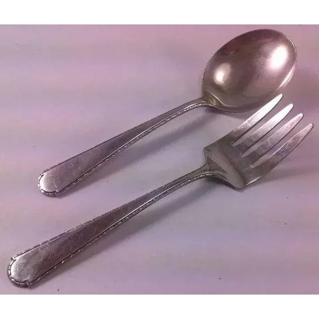 This pair of baby fork and spoon by Weidlich Sterling Spoon Co. in the Virginia pattern is precious. Weidlich was in...