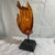 Offered here is a lovely Buddha hand lucite sculpture mounted on a black stand.