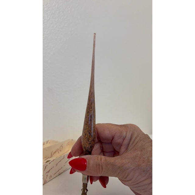 The elongated, delocate brown glass tip acts as a counterbalance, helping distribute weight towards the user's hand during...
