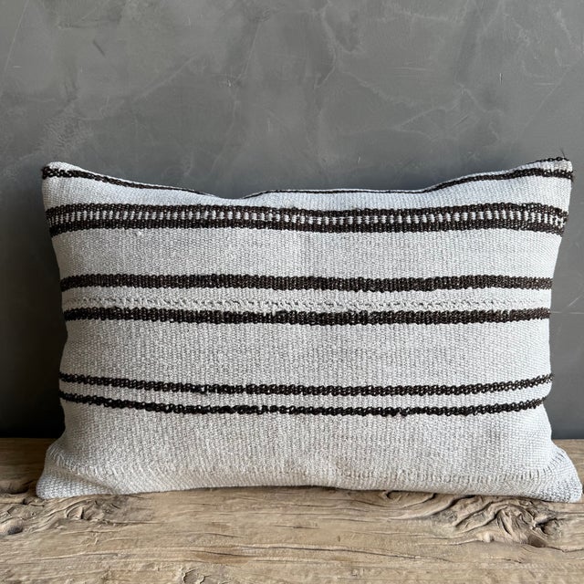 Creamy white hemp rug pillow with stripes. Soft hand, linen blend backing with zipper closure. Spot cleaning is...