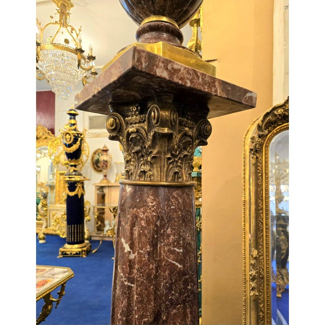 An impressive Louis XVI-style decorative centerpiece featuring shaped porcelain bodies hand-painted with finely detailed...