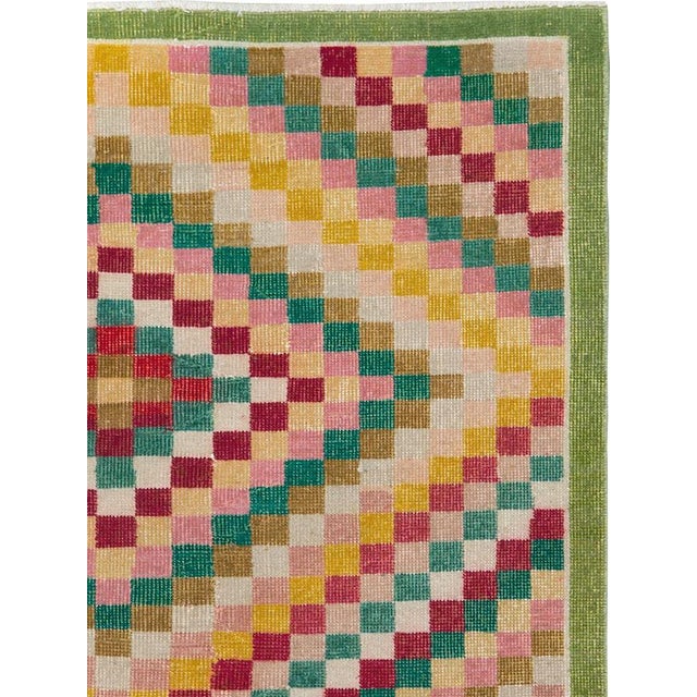 This mid-20th-century Turkish Anatolian Art Deco rug presents a vibrant checkerboard composition arranged in concentric,...