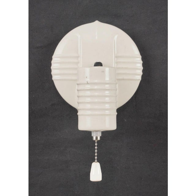 Art Deco white porcelain wall sconces with pull chains. Each sconce requires one Edison style medium base bulb. Good...