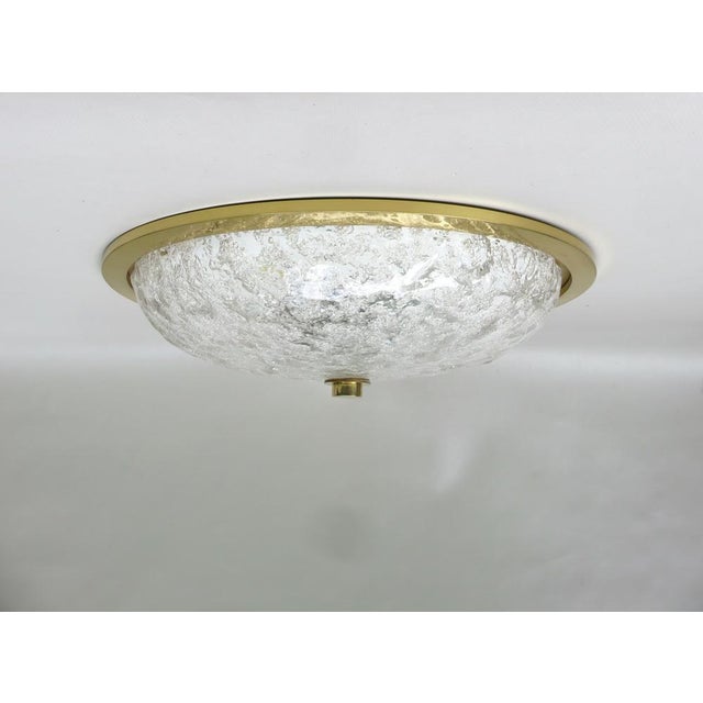 An elegant, large ceiling light manufactured by Schröder & Co. in Germany. Due to the rather opaque ice glass, it emits a...