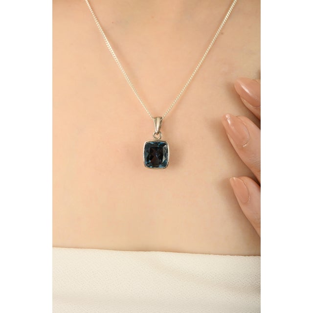 This Classic 925 Sterling Silver Pendant in 6.5 Ct Natural London Blue Topaz for Her striking pendant showcases a natural...