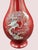 A striking Korean lacquer vase featuring intricate mother of pearl (Najeon) inlay depicting cranes in flight among...