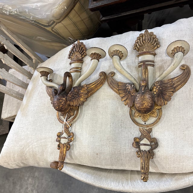 A pair of elaborately carved neoclassical painted sconces from Italy. This pair of mid 19th century scones have their...