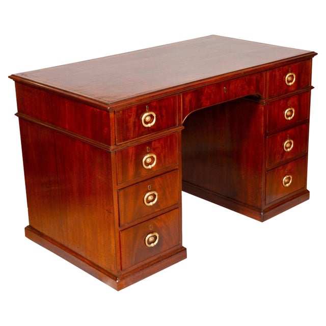 With rectangular top with inset red leather and banded edge, over a long drawer opening to A-Z lidded compartments. The...
