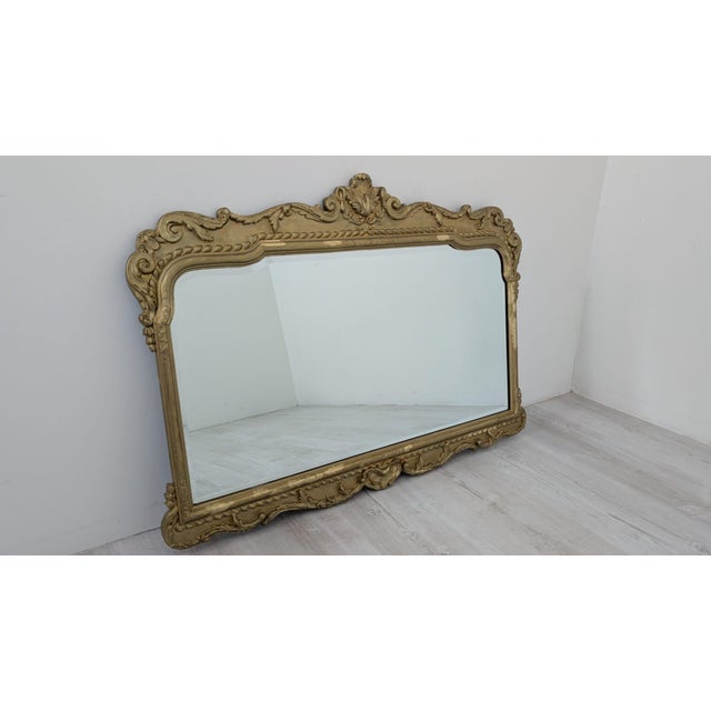 Mirror in a gilded wooden frame in the Baroque style Stylish mirror in a gilded wooden frame in the Baroque style. The...