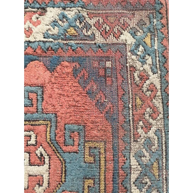 Mid century Turkish rug with beautiful geometric Kazak style design and nice colours with a pink background, blue, yellow...