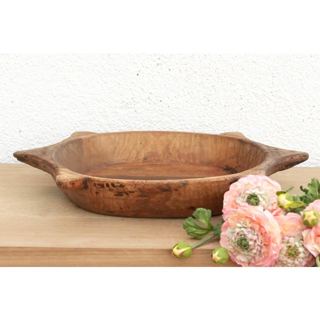 The sculptural form of this vintage bowl takes center stage. Carved from a single piece of solid hardwood, it features a...