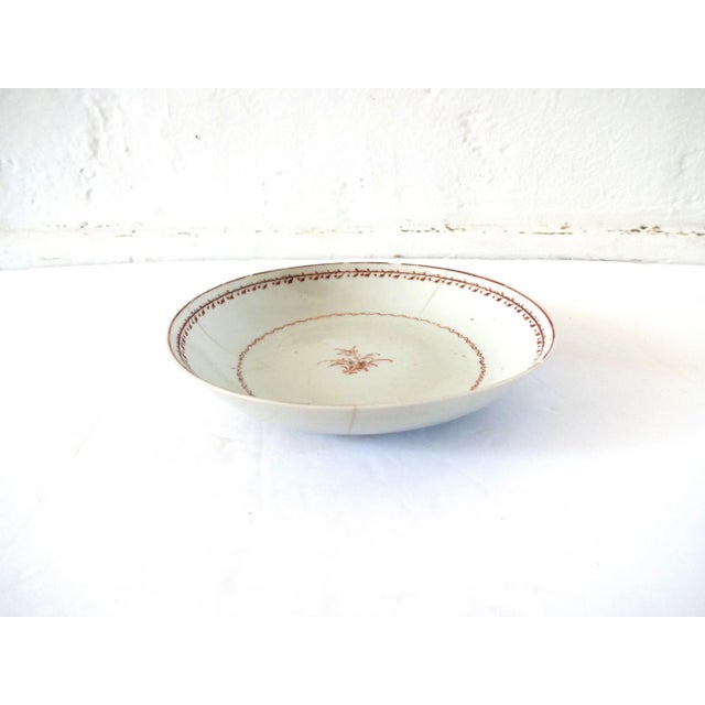 An antique dish or saucer, hand-painted with a brown monochrome leaf border and floral sprig center. Mid- to late-18th...