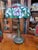 Bring the timeless charm of Tiffany art into your home with this splendid Art Nouveau table lamp, a refined and...