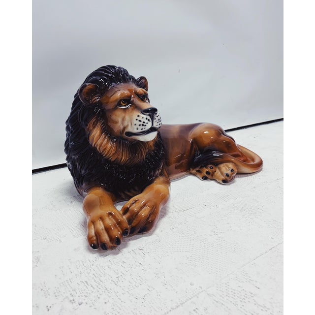 Unique handmade statue of a lion. This Hollywood Regency statue, crafted from hand-painted ceramic and made in Italy, will...
