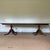 A vintage Georgian style flame-figured mahogany double-pedestal dining table with three 20” extension leaves, a long...
