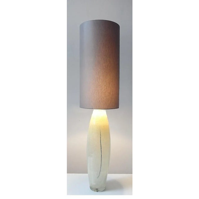 This vintage table lamp is known as the Grande Jaune. It is made from yellowish amber Murano glass and is mounted on a...