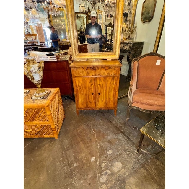 The 19th c. German Biedermeier Walnut Side Cabinet is a classic piece of furniture from the Biedermeier era, known for its...