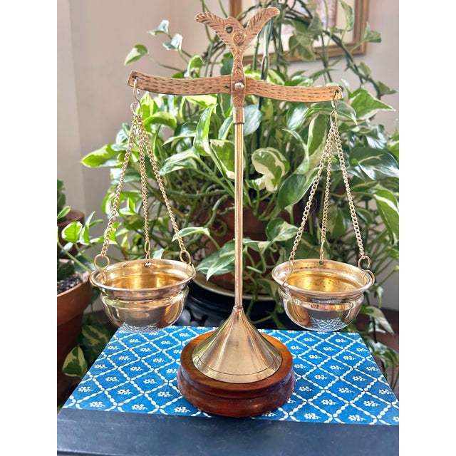 This petite scale is crafted of brass on a mahogany base. It has some age to it, so the patina lends old world charm to...