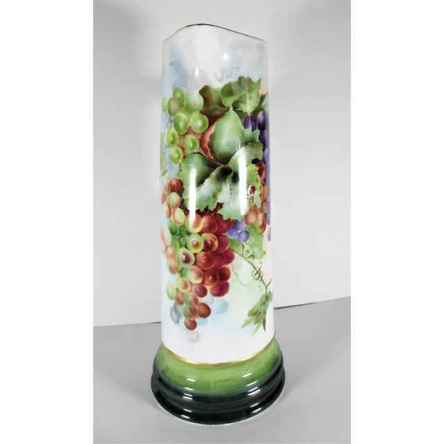 A large antique hand painted tankard or pitcher by Vienna Austria. Hallmarked on bottom with green mark. Measures 15” high...