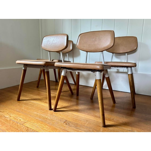 Set of four 1950 steel and oak chairs with beige naughide upholstery by Raymond Loewy for Hill Rom