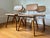 Set of four 1950 steel and oak chairs with beige naughide upholstery by Raymond Loewy for Hill Rom