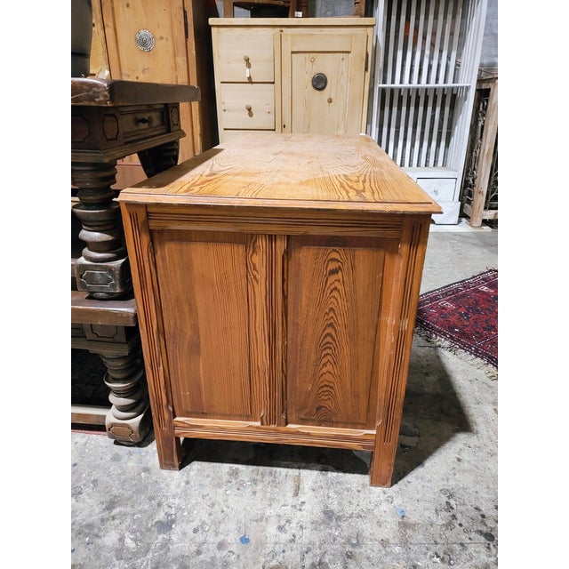 Classic pine desk with warm, pronounced grain and a clean, traditional silhouette. This substantial writing desk features...